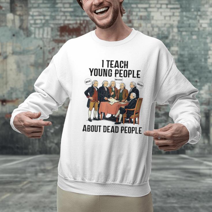 I Teach Young People About Dead-People History Teachers Men Graphic Sweatshirt, History Teacher Sweatshirts, gift for family, gift for coworker I Teach Young People About Dead-People History Teachers Men Graphic Sweatshirt, History Teacher Sweatshirts, gift for family, gift for coworker