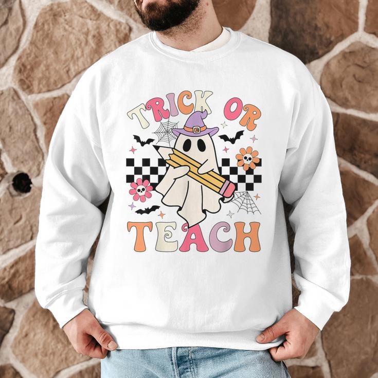 Trick Or Teach Groovy Teacher Halloween Retro Floral Ghost Men Graphic Sweatshirt, novelty gifts, funny gifts
