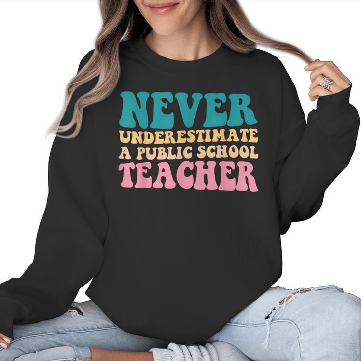 Never Underestimate A Public School Teacher Groovy Women Women Crewneck Sweatshirt