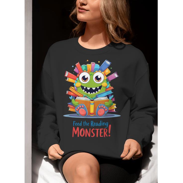 Feed The Reading Monster Halloween Teacher Women Crewneck Sweatshirt, funny gift