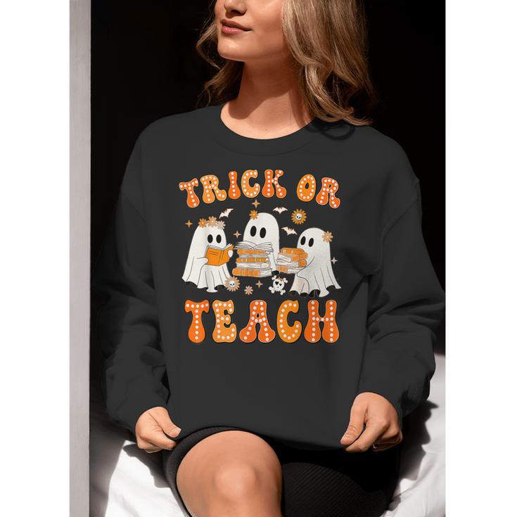 Teacher Halloween Trick Or Teach Retro Groovy Floral Ghost Women Crewneck Sweatshirt, Groovy Teacher Sweatshirts, funny gift Teacher Halloween Trick Or Teach Retro Groovy Floral Ghost Women Crewneck Sweatshirt, Groovy Teacher Sweatshirts, funny gift