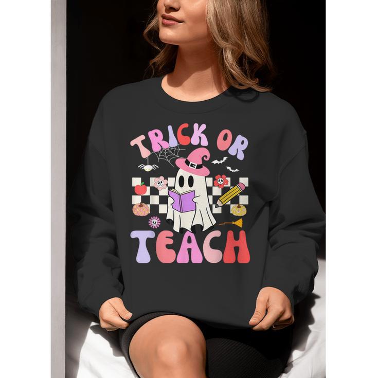 Trick Or Teach Halloween Teacher Floral Ghost Groovy Women Crewneck Sweatshirt, Groovy Teacher Sweatshirts, funny gift Trick Or Teach Halloween Teacher Floral Ghost Groovy Women Crewneck Sweatshirt, Groovy Teacher Sweatshirts, funny gift