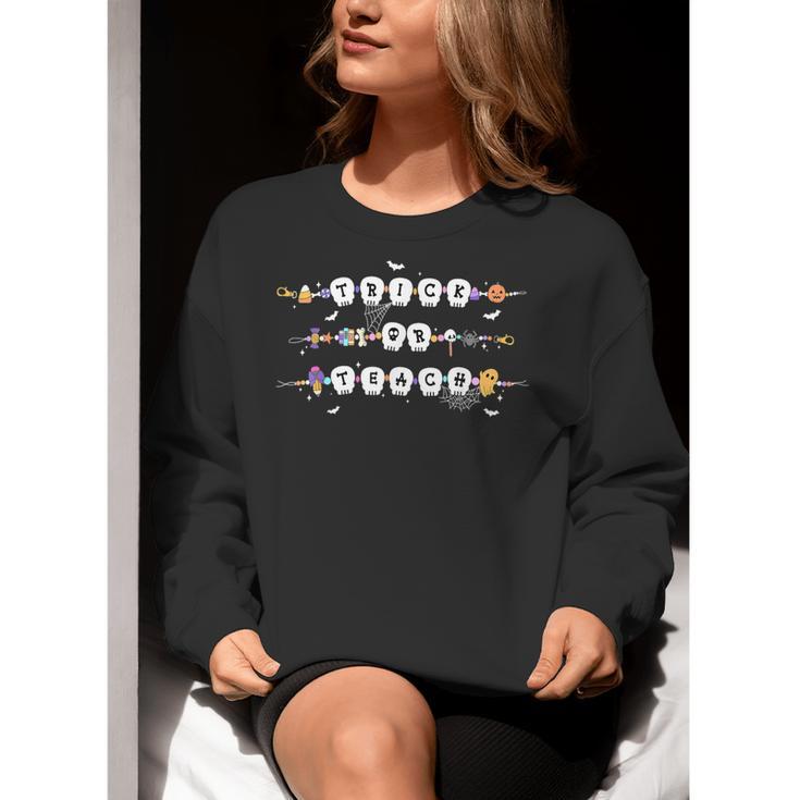 Trick Or Teach Spooky Teacher Happy Halloween Bracelet Women Crewneck Sweatshirt, funny gift Trick Or Teach Spooky Teacher Happy Halloween Bracelet Women Crewneck Sweatshirt, funny gift
