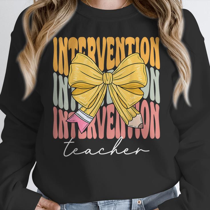 Interventionist Teacher Groovy Coquette Bow Back To School Women Crewneck Sweatshirt, Groovy Teacher Gifts, funny design