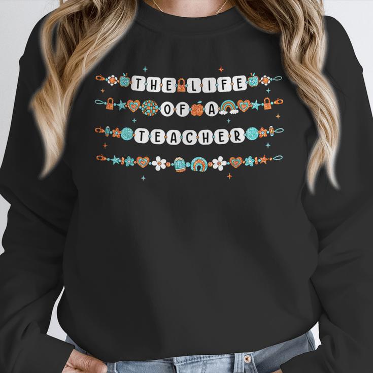 The Life Of A Teacher Friendship Bracelets Elementary School Women Crewneck Sweatshirt, funny design