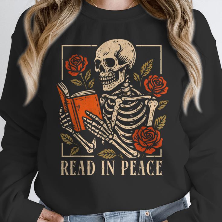 Read In Peace Skeleton Reading Book Halloween Teacher Women Crewneck Sweatshirt, funny design Read In Peace Skeleton Reading Book Halloween Teacher Women Crewneck Sweatshirt, funny design
