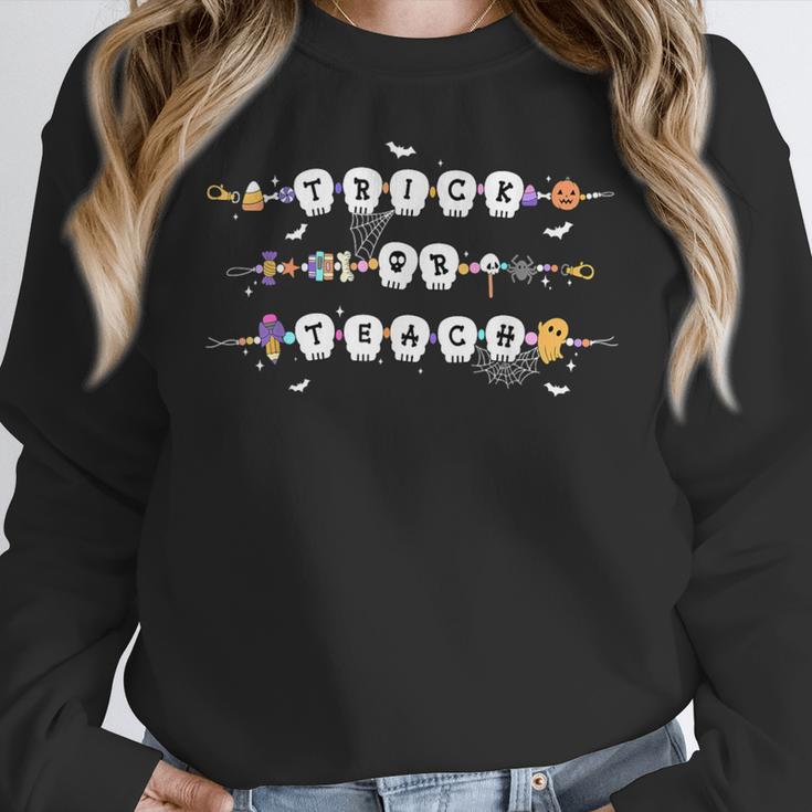 Trick Or Teach Spooky Teacher Happy Halloween Bracelet Women Crewneck Sweatshirt, funny design Trick Or Teach Spooky Teacher Happy Halloween Bracelet Women Crewneck Sweatshirt, funny design