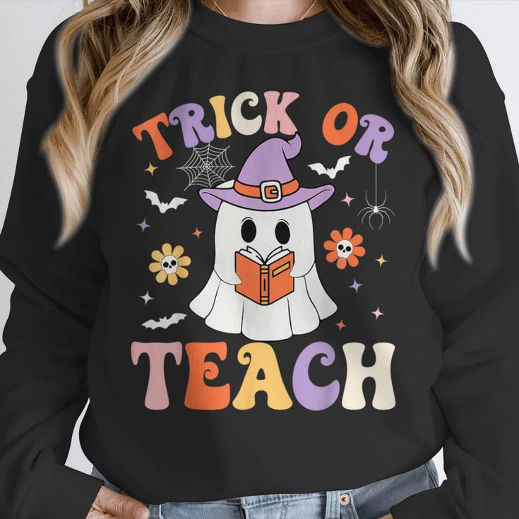 Trick Or Teach Teacher Groovy Ghost Halloween Teacher Women Crewneck Sweatshirt, Groovy Teacher Gifts, funny design Trick Or Teach Teacher Groovy Ghost Halloween Teacher Women Crewneck Sweatshirt, Groovy Teacher Gifts, funny design