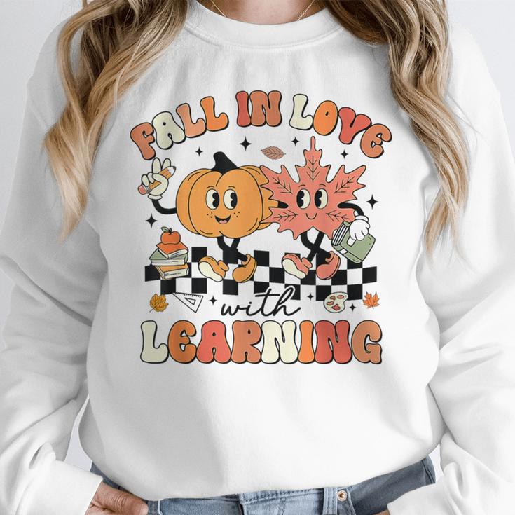 Fall In Love With Learning Teacher Retro Thanksgiving Women Crewneck Sweatshirt, funny design Fall In Love With Learning Teacher Retro Thanksgiving Women Crewneck Sweatshirt, funny design