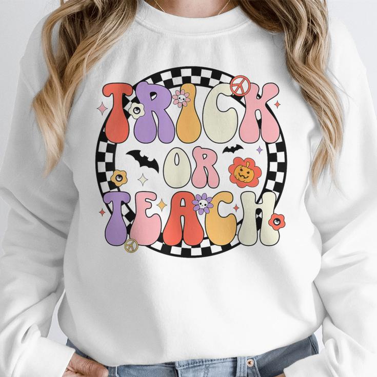 Trick Or Teach Retro Groovy Halloween Teacher Women Crewneck Sweatshirt, Groovy Teacher Gifts, funny design Trick Or Teach Retro Groovy Halloween Teacher Women Crewneck Sweatshirt, Groovy Teacher Gifts, funny design