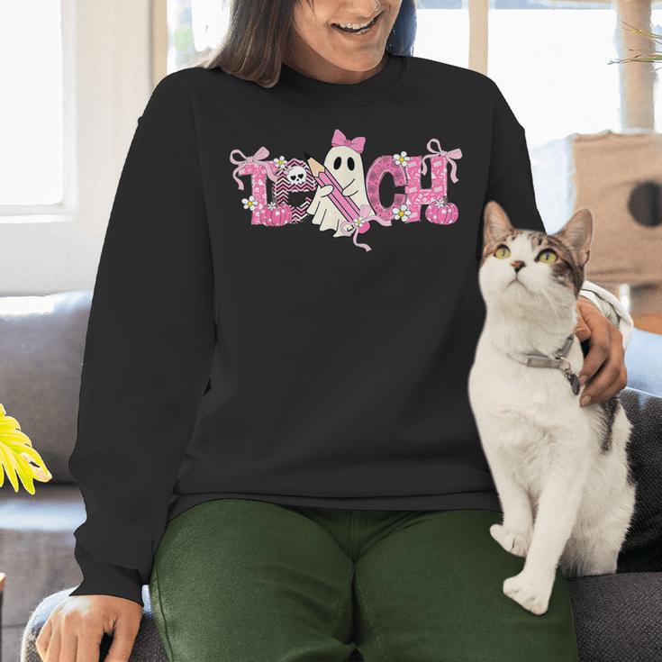 Pink Ghost Teach Halloween Teacher In Spooky Season Women Crewneck Sweatshirt, gift for family, gift for coworker Pink Ghost Teach Halloween Teacher In Spooky Season Women Crewneck Sweatshirt, gift for family, gift for coworker