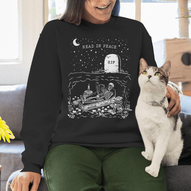 Read In Peace Skeleton Halloween Book Reading Spooky Teacher Women Crewneck Sweatshirt, gift for family, gift for coworker Read In Peace Skeleton Halloween Book Reading Spooky Teacher Women Crewneck Sweatshirt, gift for family, gift for coworker