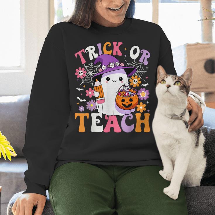 Trick Or Teach Groovy Teacher Ghost Halloween Teacher Women Crewneck Sweatshirt, Groovy Teacher Sweatshirts, gift for family, gift for coworker Trick Or Teach Groovy Teacher Ghost Halloween Teacher Women Crewneck Sweatshirt, Groovy Teacher Sweatshirts, gift for family, gift for coworker