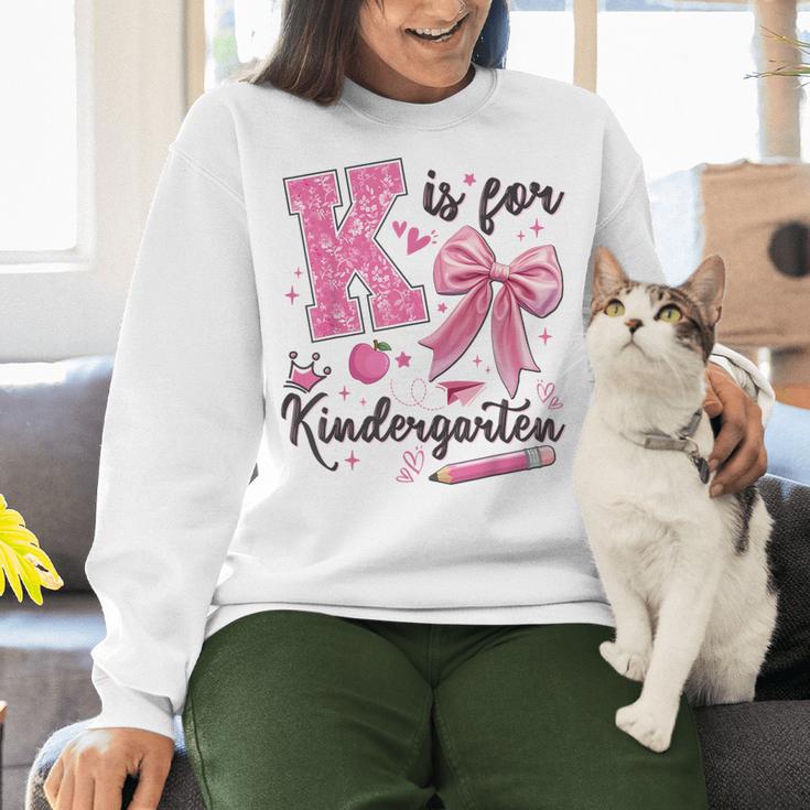 K Is For Kindergarten Teacher Coquette Bow Back To School Women Crewneck Sweatshirt, gift for family, gift for coworker K Is For Kindergarten Teacher Coquette Bow Back To School Women Crewneck Sweatshirt, gift for family, gift for coworker