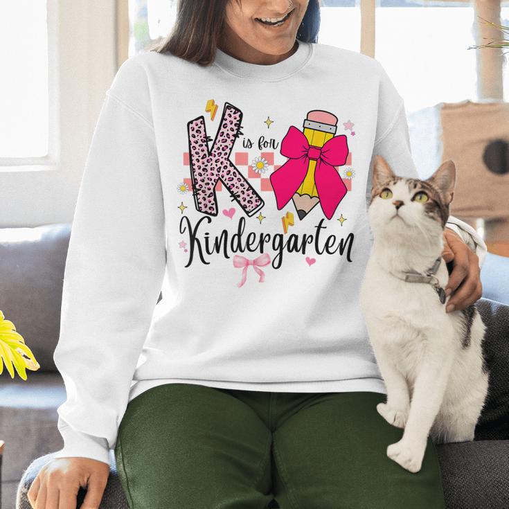 K Is For Kindergarten Teacher Coquette Bow Back To School Women Crewneck Sweatshirt, gift for family, gift for coworker K Is For Kindergarten Teacher Coquette Bow Back To School Women Crewneck Sweatshirt, gift for family, gift for coworker