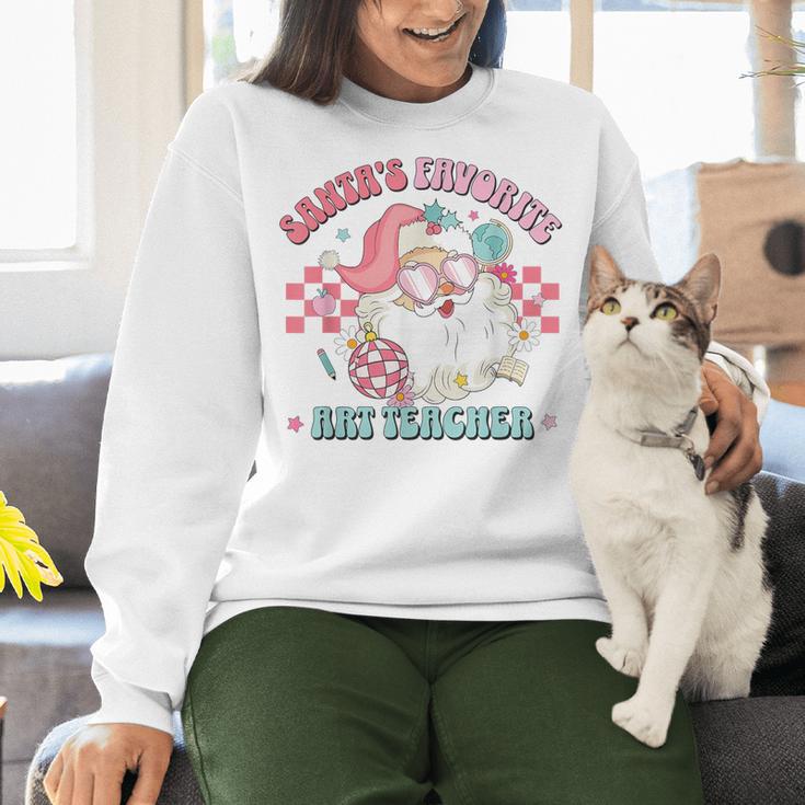Retro Pink Christmas Santa's Favorite Art Teacher Artist Women Crewneck Sweatshirt, gift for family, gift for coworker Retro Pink Christmas Santa's Favorite Art Teacher Artist Women Crewneck Sweatshirt, gift for family, gift for coworker