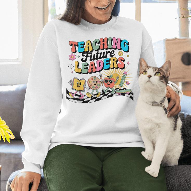 Retro Teaching Future Leaders Groovy Teacher Back To School Women Crewneck Sweatshirt, Future Teacher Sweatshirts, Groovy Teacher Sweatshirts, gift for family, gift for coworker