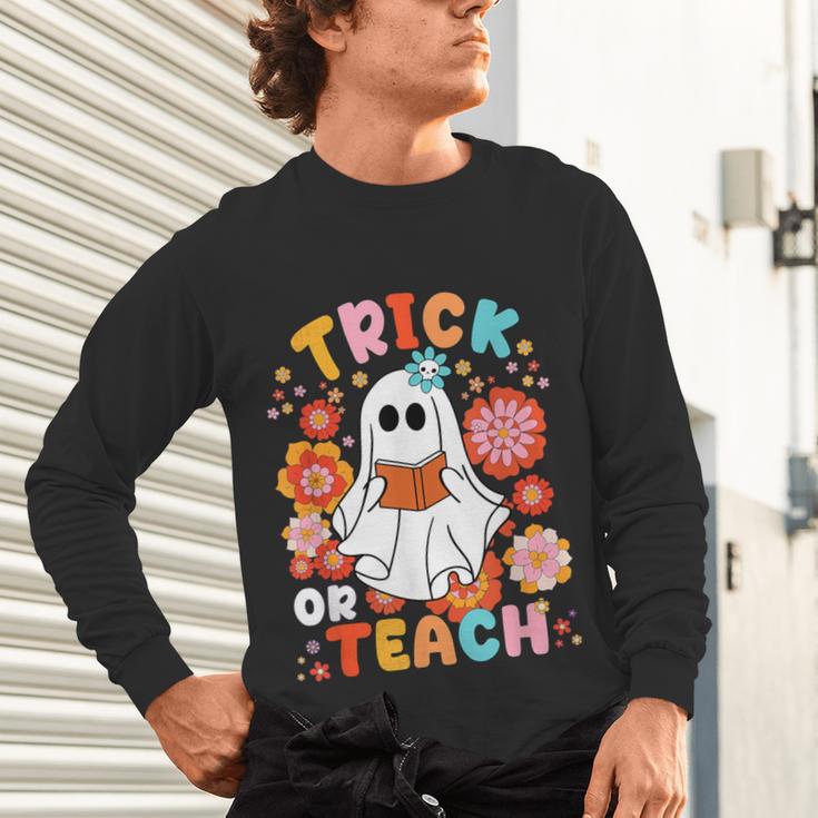 Groovy Halloween Trick Or Teach Retro Floral Ghost Teacher For Men Women Kids Unisex Long Sleeve T-Shirt, gift for family, gift for coworker Groovy Halloween Trick Or Teach Retro Floral Ghost Teacher For Men Women Kids Unisex Long Sleeve T-Shirt, gift for family, gift for coworker