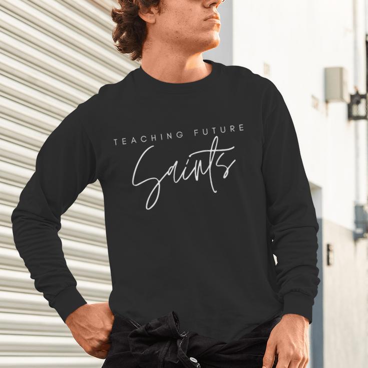 Teaching Future Saints Catholic Teacher Unisex Long Sleeve T-Shirt, gift for family, gift for coworker Teaching Future Saints Catholic Teacher Unisex Long Sleeve T-Shirt, gift for family, gift for coworker