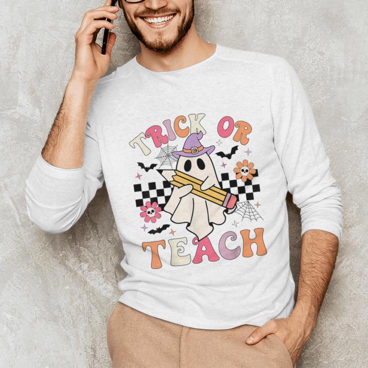 Trick Or Teach Groovy Teacher Halloween Retro Floral Ghost Unisex Long Sleeve T-Shirt, funny gift Trick Or Teach Groovy Teacher Halloween Retro Floral Ghost Unisex Long Sleeve T-Shirt, funny gift