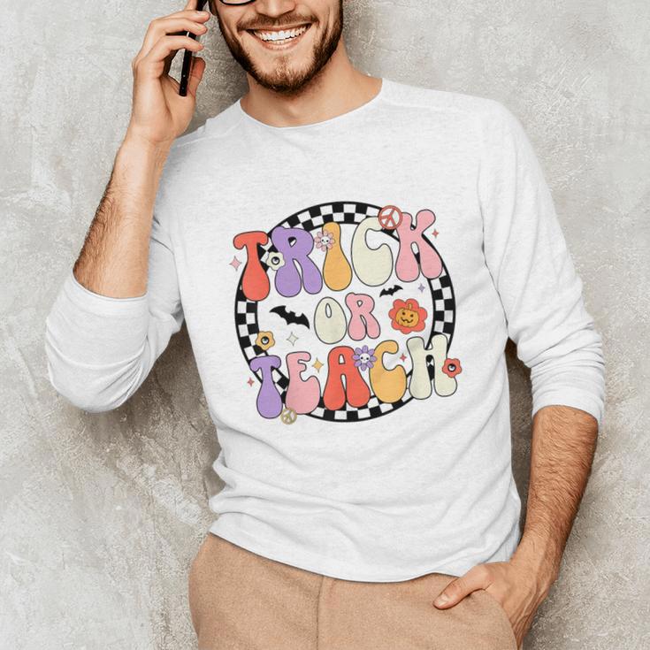 Trick Or Teach Retro Groovy Halloween Teacher Unisex Long Sleeve T-Shirt, funny gift Trick Or Teach Retro Groovy Halloween Teacher Unisex Long Sleeve T-Shirt, funny gift