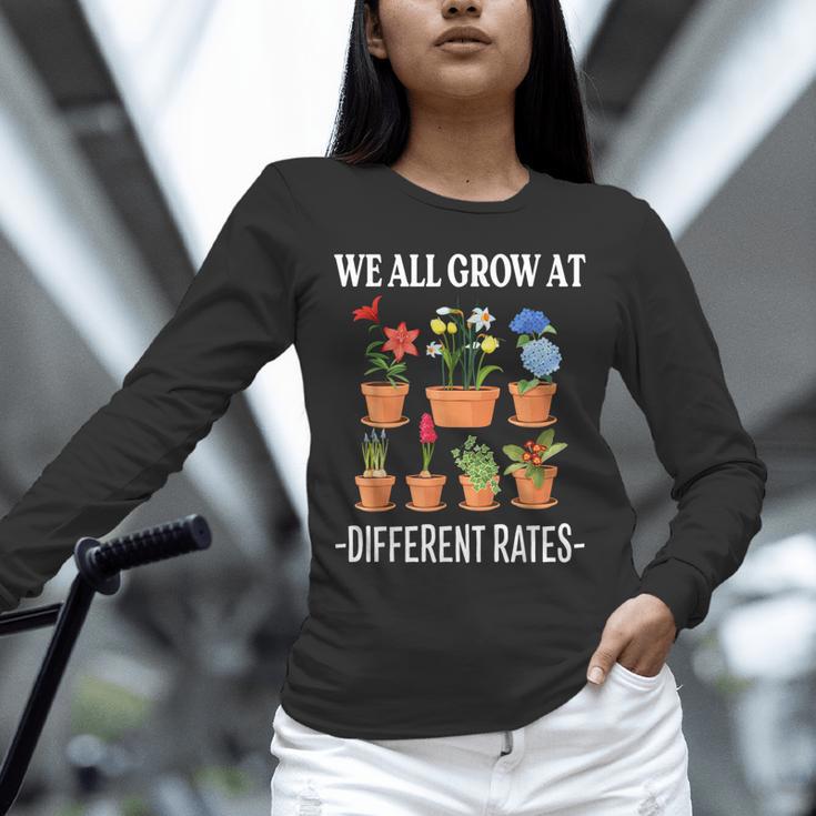 We All Grow At Different Rates Back To School Teacher Unisex Long Sleeve T-Shirt, novelty gifts, funny gifts