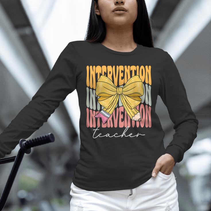 Interventionist Teacher Groovy Coquette Bow Back To School Unisex Long Sleeve T-Shirt, novelty gifts, funny gifts Interventionist Teacher Groovy Coquette Bow Back To School Unisex Long Sleeve T-Shirt, novelty gifts, funny gifts