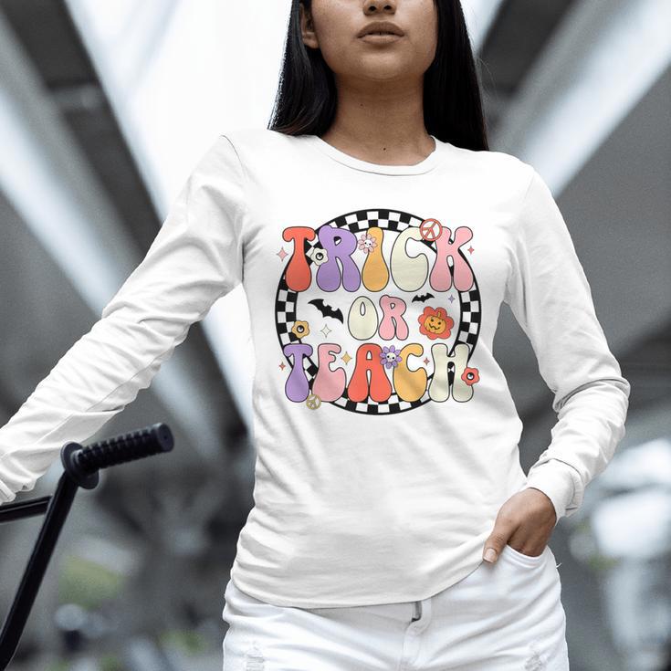 Trick Or Teach Retro Groovy Halloween Teacher Unisex Long Sleeve T-Shirt, novelty gifts, funny gifts Trick Or Teach Retro Groovy Halloween Teacher Unisex Long Sleeve T-Shirt, novelty gifts, funny gifts