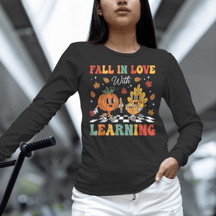 Groovy Fall In Love With Learning Autumn Pumpkin Teacher Women Long Sleeve T-Shirt, Groovy Teacher Shirts, gift for family, gift for coworker