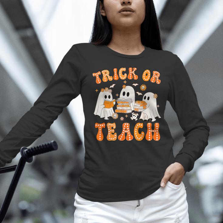 Teacher Halloween Trick Or Teach Retro Groovy Floral Ghost Women Long Sleeve T-Shirt, Groovy Teacher Shirts, gift for family, gift for coworker Teacher Halloween Trick Or Teach Retro Groovy Floral Ghost Women Long Sleeve T-Shirt, Groovy Teacher Shirts, gift for family, gift for coworker