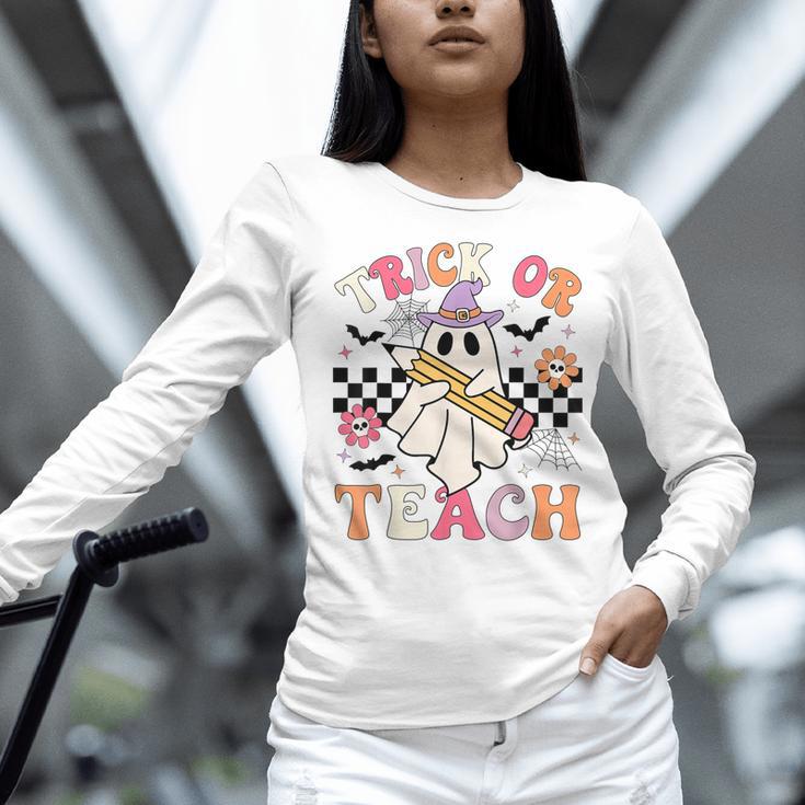 Trick Or Teach Groovy Teacher Halloween Retro Floral Ghost Women Long Sleeve T-Shirt, Groovy Teacher Shirts, gift for family, gift for coworker