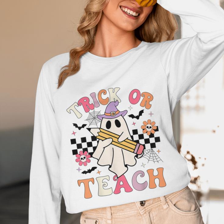 Trick Or Teach Groovy Teacher Halloween Retro Floral Ghost Women Long Sleeve T-Shirt, novelty gifts, funny gifts
