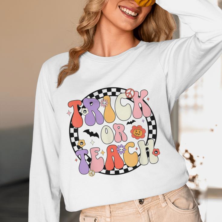 Trick Or Teach Retro Groovy Halloween Teacher Women Long Sleeve T-Shirt, novelty gifts, funny gifts