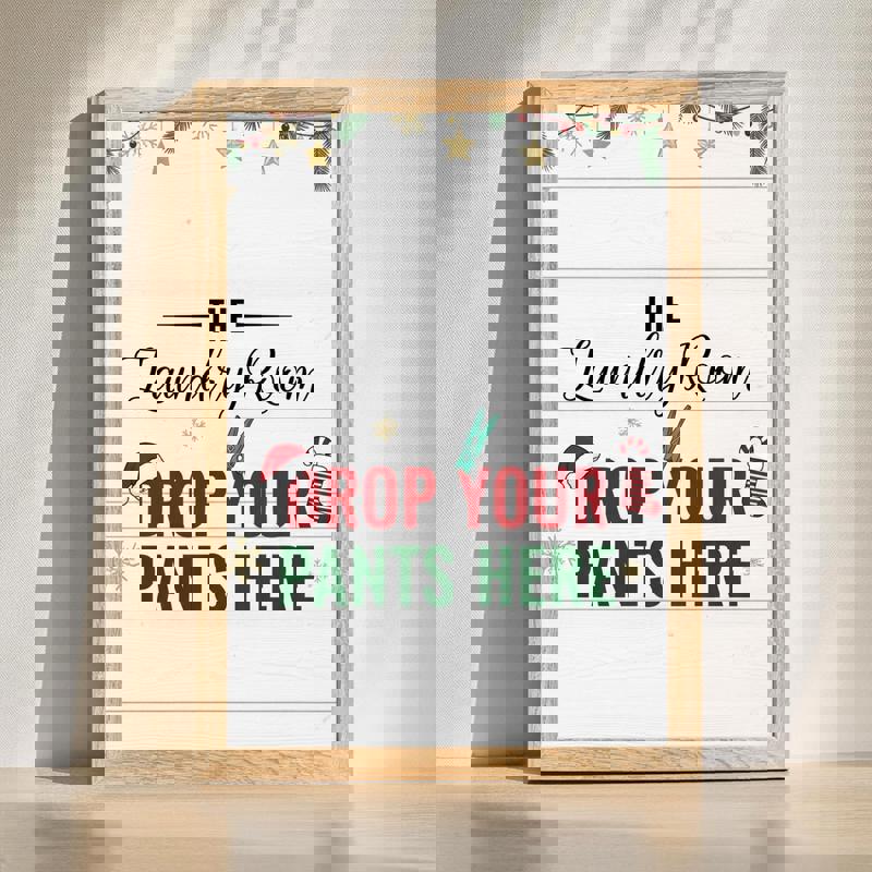 Christmas laundry room canvas with "Drop Your Pants Here" quote in festive red and green typography, holiday decor sign | Familywalldecor