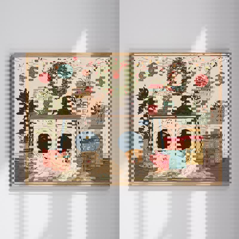 Cozy Christmas canvas wall art with a festive laundry room scene, washer and dryer trimmed with garland, ideal for laundry decor | Familywalldecor