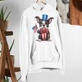 Boston Terrier Puppy Dog Holds His American Flag 4th Of July Women's Hoodie, American Boston Terrier Hoodies, Boston Terrier 4th Of July Hoodies, funny gift